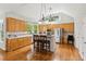 Bright kitchen features stainless steel appliances, wooden cabinets, and center island with pendant lighting at 878 Treadstone Overlook, Suwanee, GA 30024