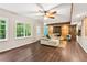 Spacious living room with wood floors, large windows, a sliding barn door, and comfortable furniture at 878 Treadstone Overlook, Suwanee, GA 30024