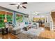 Open-concept living room with hardwood floors and large sectional sofa at 878 Treadstone Overlook, Suwanee, GA 30024