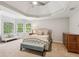 Relaxing main bedroom features a tray ceiling, neutral tones, sitting area, and lots of natural light at 878 Treadstone Overlook, Suwanee, GA 30024