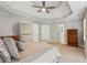 Spacious main bedroom featuring tray ceiling and an ensuite bathroom with lots of storage space at 878 Treadstone Overlook, Suwanee, GA 30024