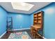 Bright blue office space with wooden floors, a skylight, desk, chair and area rug at 878 Treadstone Overlook, Suwanee, GA 30024