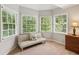 Bright sitting area with neutral tones and lots of natural light with views of the surrounding trees at 878 Treadstone Overlook, Suwanee, GA 30024