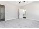 Bright bedroom with neutral walls and plush carpeting, leading to an ensuite bathroom with granite counters at 1100 Pleasant Grove Church Rd, Villa Rica, GA 30180