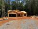 Unfinished home with wooden framework, on a large lot surrounded by trees at 1100 Pleasant Grove Church Rd, Villa Rica, GA 30180