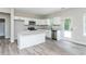 Bright kitchen features white cabinets, stainless appliances, granite countertops, and luxury vinyl plank flooring at 1100 Pleasant Grove Church Rd, Villa Rica, GA 30180