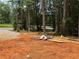 A vacant lot with trees in the background and construction materials laying around at 1100 Pleasant Grove Church Rd, Villa Rica, GA 30180