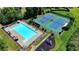 Aerial view of a community pool, tennis courts and playground at 2765 Turning Leaf Dr, Lawrenceville, GA 30044