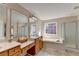 Primary bath featuring dual sinks, soaking tub, and glass enclosed shower at 2765 Turning Leaf Dr, Lawrenceville, GA 30044