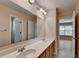 Bathroom with double sinks and large mirror, plus a door leading to another room at 2765 Turning Leaf Dr, Lawrenceville, GA 30044