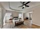 Spacious bedroom featuring hardwood floors, a ceiling fan, and tray ceiling at 2765 Turning Leaf Dr, Lawrenceville, GA 30044