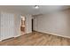 Bright bedroom boasts wood-look flooring and neutral paint, with a view to an adjacent bathroom at 2765 Turning Leaf Dr, Lawrenceville, GA 30044