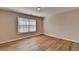 Bedroom featuring hardwood floors, window, and natural light at 2765 Turning Leaf Dr, Lawrenceville, GA 30044