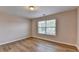 Neutral bedroom with wood-look floors and large window letting in natural light at 2765 Turning Leaf Dr, Lawrenceville, GA 30044