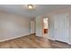 Bedroom features wood-look flooring, neutral paint, and doors leading to a bathroom at 2765 Turning Leaf Dr, Lawrenceville, GA 30044