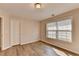 Bedroom featuring hardwood floors, a window, and a door at 2765 Turning Leaf Dr, Lawrenceville, GA 30044