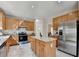 Spacious kitchen with stainless steel appliances and center island and tile floors at 2765 Turning Leaf Dr, Lawrenceville, GA 30044