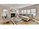 Comfortable living room featuring a fireplace and large windows, and modern furnishings at 2765 Turning Leaf Dr, Lawrenceville, GA 30044