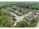 Aerial view of a residential neighborhood with mature trees and well-maintained lawns at 3120 Henderson Walk, Atlanta, GA 30340