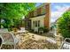 Brick patio with an enclosed porch and outdoor seating featuring a brick house surrounded by trees at 3120 Henderson Walk, Atlanta, GA 30340