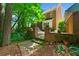 Brick patio and garden of a brick house with surrounding trees and greenery at 3120 Henderson Walk, Atlanta, GA 30340