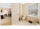 Bright, tiled bathroom with a toilet, vanity, and window, located off the bedroom at 3120 Henderson Walk, Atlanta, GA 30340