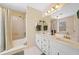Bright bathroom featuring a double sink vanity, tiled shower/tub, and decorative lighting at 3120 Henderson Walk, Atlanta, GA 30340