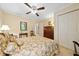 Traditional bedroom featuring neutral walls, a floral comforter, ceiling fan, and closet at 3120 Henderson Walk, Atlanta, GA 30340