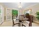 This dining room features a round wood table and french doors leading to the outside at 3120 Henderson Walk, Atlanta, GA 30340