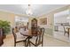 This dining room features a round wood table and an open view into the kitchen at 3120 Henderson Walk, Atlanta, GA 30340
