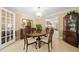 This dining room features a round wood table and an open view into the living room at 3120 Henderson Walk, Atlanta, GA 30340