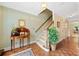 Inviting entryway with hardwood floors, staircase, and decorative table with plant at 3120 Henderson Walk, Atlanta, GA 30340