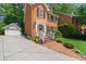 Charming two-story brick home with a detached garage and well-maintained front yard at 3120 Henderson Walk, Atlanta, GA 30340