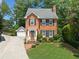 Charming brick home with lush lawn, manicured landscaping, and an inviting brick walkway at 3120 Henderson Walk, Atlanta, GA 30340