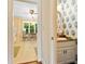 A view from the hallway looking into a kitchen with eating area and powder room at 3120 Henderson Walk, Atlanta, GA 30340
