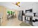 Bright eat-in kitchen featuring white cabinets, stainless steel appliances, and a cozy dining area near the window at 3120 Henderson Walk, Atlanta, GA 30340
