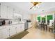 Bright eat-in kitchen featuring white cabinets, stainless steel appliances, and a cozy dining area near the window at 3120 Henderson Walk, Atlanta, GA 30340