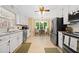 The kitchen has white cabinets, stainless steel appliances, and tile floors at 3120 Henderson Walk, Atlanta, GA 30340