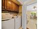 Laundry room with wood cabinets and a door leading to the kitchen at 3120 Henderson Walk, Atlanta, GA 30340