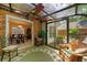 This sun room has a brick accent wall and a view into the dining room at 3120 Henderson Walk, Atlanta, GA 30340