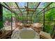 This is a sun room with a glass ceiling and brick floor leading to the outside at 3120 Henderson Walk, Atlanta, GA 30340