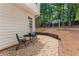 Cozy back patio area with a small table and chairs, offering a perfect spot for relaxation and outdoor enjoyment at 4816 Morning Chase Nw, Acworth, GA 30102
