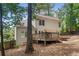 View of the home's back exterior, showcasing a deck and outdoor patio in the landscaped backyard at 4816 Morning Chase Nw, Acworth, GA 30102