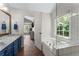 Bright bathroom with tub, shower, marble-top vanity, and wood-look tile floors at 4816 Morning Chase Nw, Acworth, GA 30102