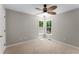 Bedroom with neutral carpeting, ceiling fan, and bright window overlooking trees at 4816 Morning Chase Nw, Acworth, GA 30102