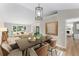 Open-concept dining room adjacent to living room with stylish lighting at 4816 Morning Chase Nw, Acworth, GA 30102
