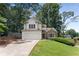 Charming home featuring a two-car garage, stone accents, and lush landscaping at 4816 Morning Chase Nw, Acworth, GA 30102
