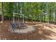 Charming fire pit area with Adirondack chairs and a swing, creating a welcoming outdoor gathering space at 4816 Morning Chase Nw, Acworth, GA 30102