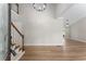 Bright foyer featuring wood floors, a staircase, and stylish lighting at 4816 Morning Chase Nw, Acworth, GA 30102