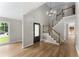 Bright foyer featuring wood floors, a staircase, and stylish lighting at 4816 Morning Chase Nw, Acworth, GA 30102